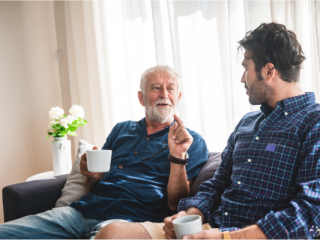 Two men sitting on a couch together
